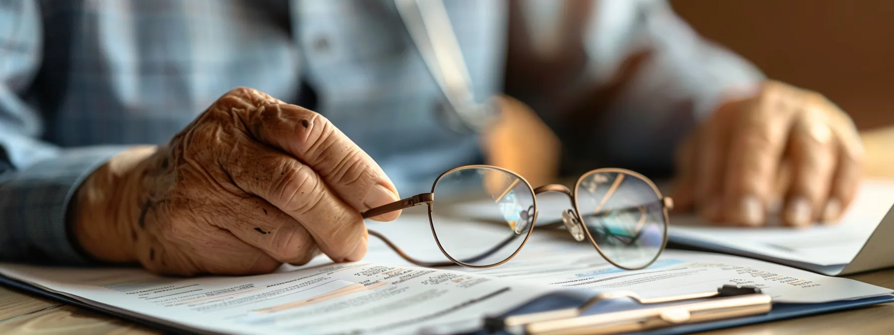 a senior citizen reviewing a detailed comparison chart of medicare advantage and original medicare plans, surrounded by medical documents and a pair of glasses.